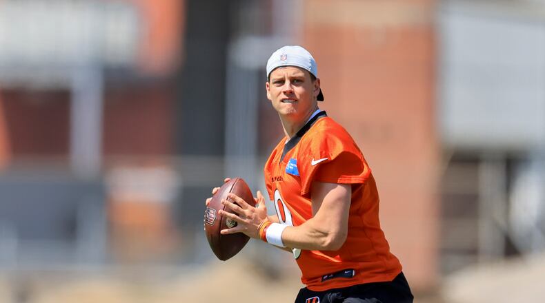 Cincinnati Bengals' Joe Burrow looks to pass as he participates in a drill during an NFL football practice in Cincinnati, Tuesday, May 24, 2022. (AP Photo/Aaron Doster)