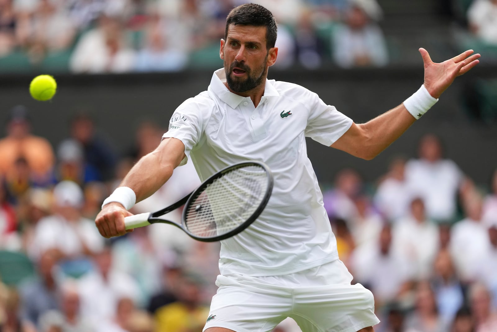 Novak Djokovic of Serbia returns to Miomir Kecmanovic of Serbia during a third round men's singles match at the Wimbledon Tennis Championships in London, Saturday, July 5, 2025. (AP Photo/Kirsty Wigglesworth)