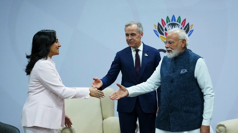 Canada's Prime Minister Mark Carney, middle, introduces Minister of Foreign Affairs Anita Anand, left, during a bilateral meeting with Indian Prime Minister Narendra Modi during the G20 Summit, in Johannesburg, Sunday, Nov. 23, 2025. (Sean Kilpatrick/The Canadian Press via AP)