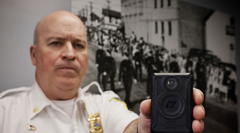 Middletown Acting Police Chief Eric Crank with a body camera that supervisors are slated to begin wearing this spring. NICK GRAHAM/STAFF
