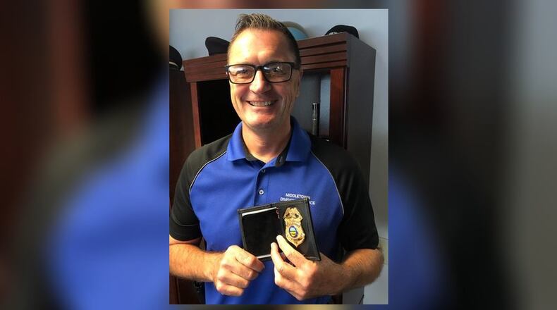 Scott Reeve, who spent his entire 35-year career with the Middletown Division of Police, retired last week. He was presented his retirement badge by Chief David Birk during his party. RICK McCRABB/STAFF