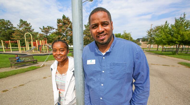 Samy Broyles has been named the new director of the Booker T. Washington Center. Tif Johnson and Samy Broyles stand at the Hamiton park at Pershing Avenue and Neilan Boulevard where a 17 Strong micro-grant, combined with in-kind labor from city agencies, will remake the basketball court there. GREG LYNCH / STAFF