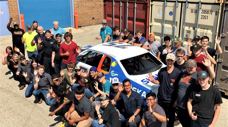 Most high school classroom projects don’t include creating a race car from a junked vehicle and then getting it racetrack ready to compete but for the first time that’s exactly what Butler Tech students are doing. And not only are the students in Butler Tech’s Auto Collision and Automotive Technology programs (pictured around their racer) getting to build a racer from the wheels up but they are also raising money through race sponsors to buy school supplies for needy students. (Photo By Michael D. Clark\Journal-News)