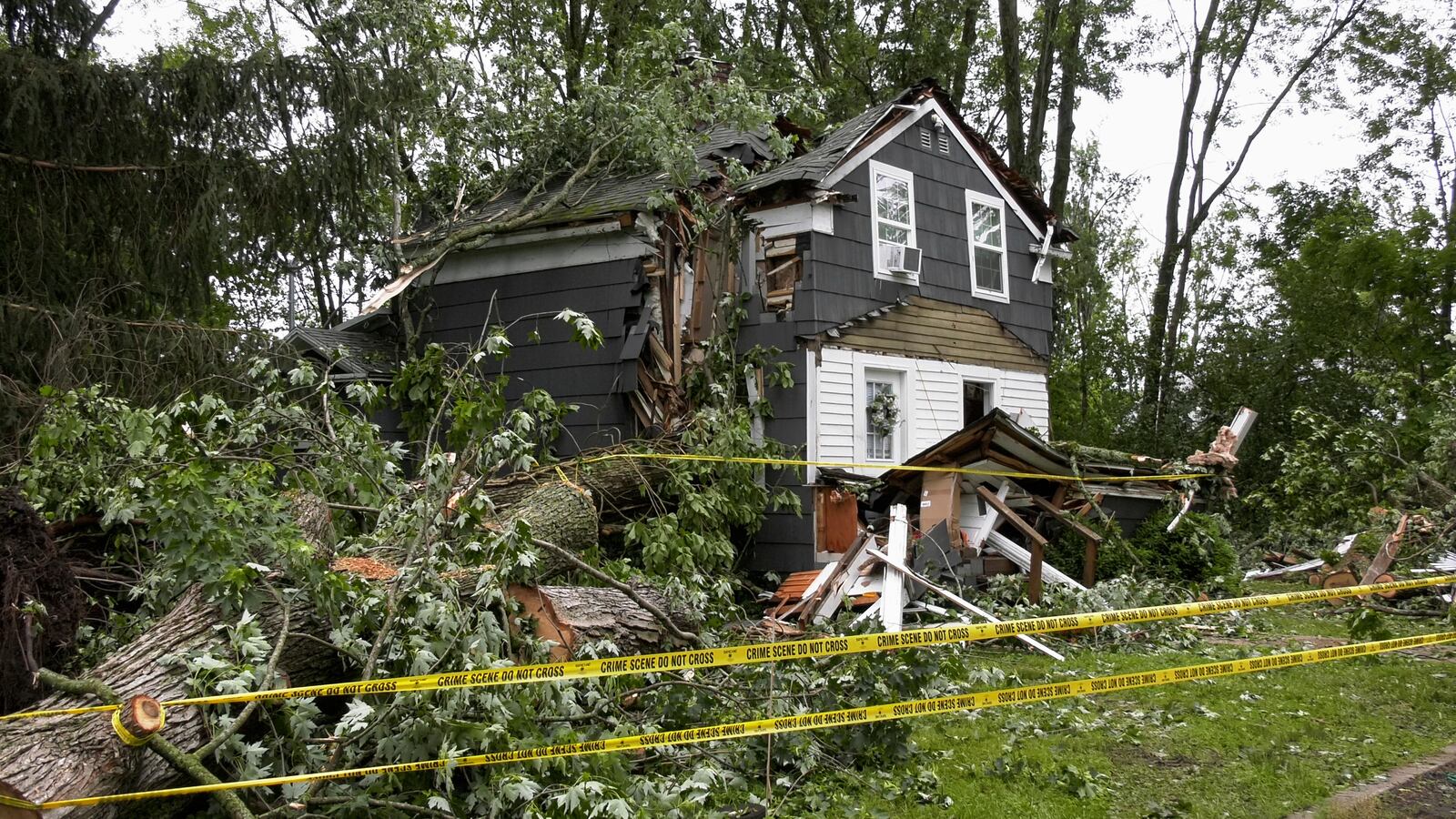 A home in Clark Mills, N.Y., that had a tree fall through it during a severe storm in the early morning, Sunday, June 22, 2025. (Tom Connolly/Spectrum News via AP)