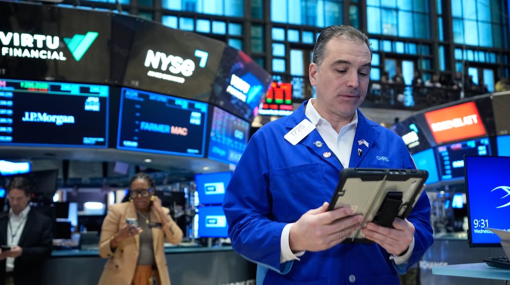 Christopher Lagana works on the floor at the New York Stock Exchange in New York, Wednesday, March 18, 2026. (AP Photo/Seth Wenig)