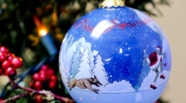The Hamilton Police Department’s 2015 Christmas ornaments feature their new police dog, Flash, chasing the Grinch. They have been doing custom ornaments since 2007. NICK GRAHAM/STAFF