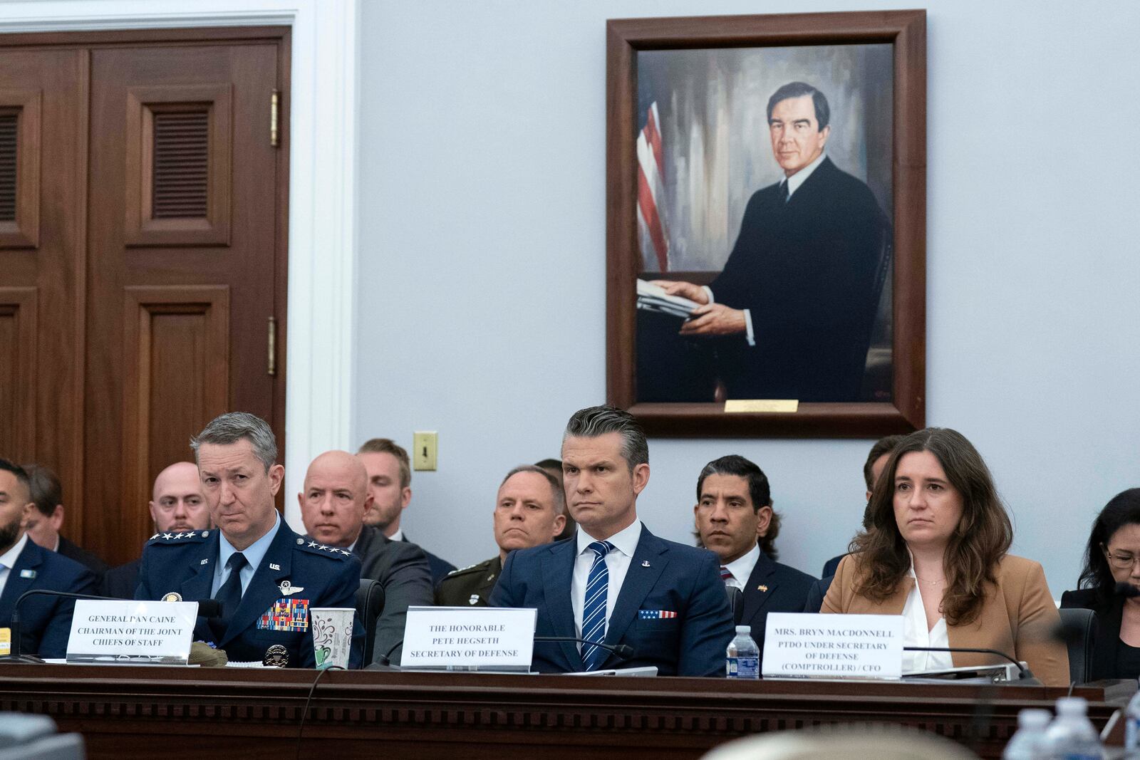 The Chairman of the Joint Chiefs of Staff General Dan Caine, left, Department of Defense Secretary Pete Hegseth and Bryn MacDonnell, Special Assistant to the Secretary of Defense, Performing the Duties of the Under Secretary of Defense and Chief Financial Officer, testify before the House Committee on Appropriations subcommittee oversight hearing on the Department of Defense, on Capitol Hill in Washington, Tuesday, June 10, 2025. (AP Photo/Jose Luis Magana)