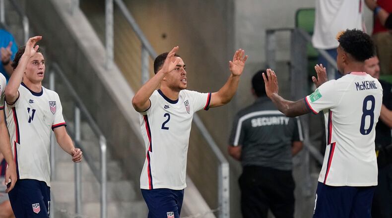 United States' Sergiño Dest (2) celebrates with Weston McKennie (8) after the team scored against Jamaica during a FIFA World Cup qualifying soccer match, Thursday, Oct. 7, 2021, in Austin, Texas. (AP Photo/Eric Gay)