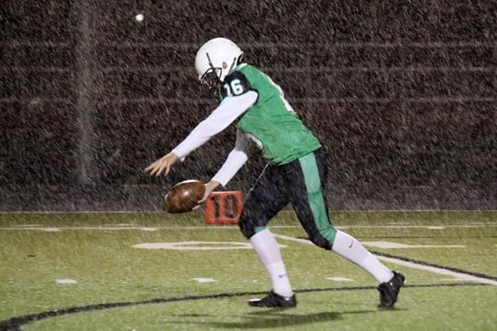 Badin’s Rocky Anzalone punts as the rain comes down Friday night during a 38-21 triumph over Chaminade Julienne at Fairfield Stadium in Fairfield CONTRIBUTED PHOTO BY TERRI ADAMS