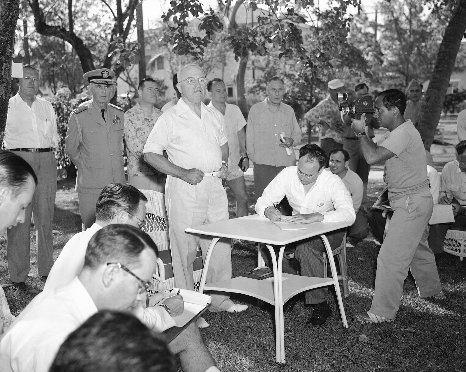 FILE - President Harry Truman holds a vacation press conference surrounded by aides and members of the media on Little White House Lawn in Key West, Fla., March 18, 1949. (AP Photo/File)