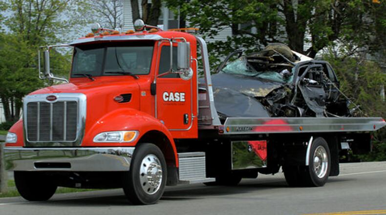 A flatbed tow truck hauls away the suspect's vehicle that allegedly killed Warren County Sheriff's Sgt. Brian Dulle, 36, of Lebanon, early Tuesday morning, May 11, 2011.