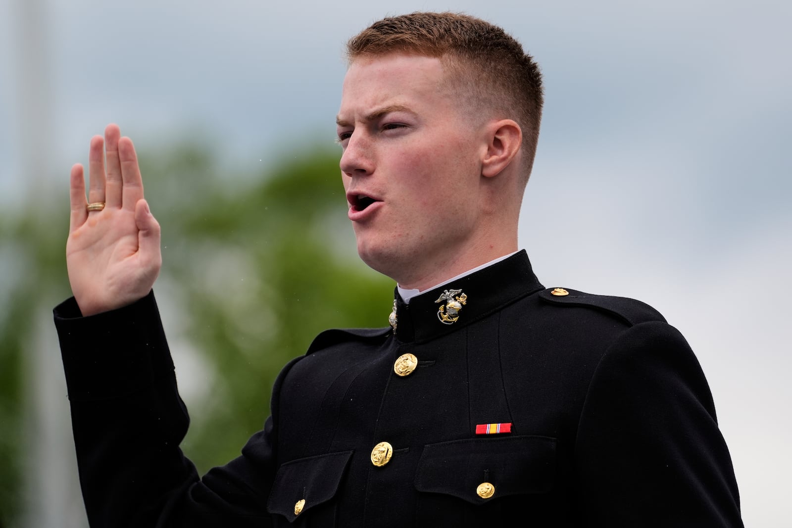A graduate of the U.S. Naval Academy takes the Marine Corps oath during the academy's graduation and commissioning ceremony, at the U.S. Naval Academy in Annapolis, Md., Friday, May 23, 2025. (AP Photo/Stephanie Scarbrough)