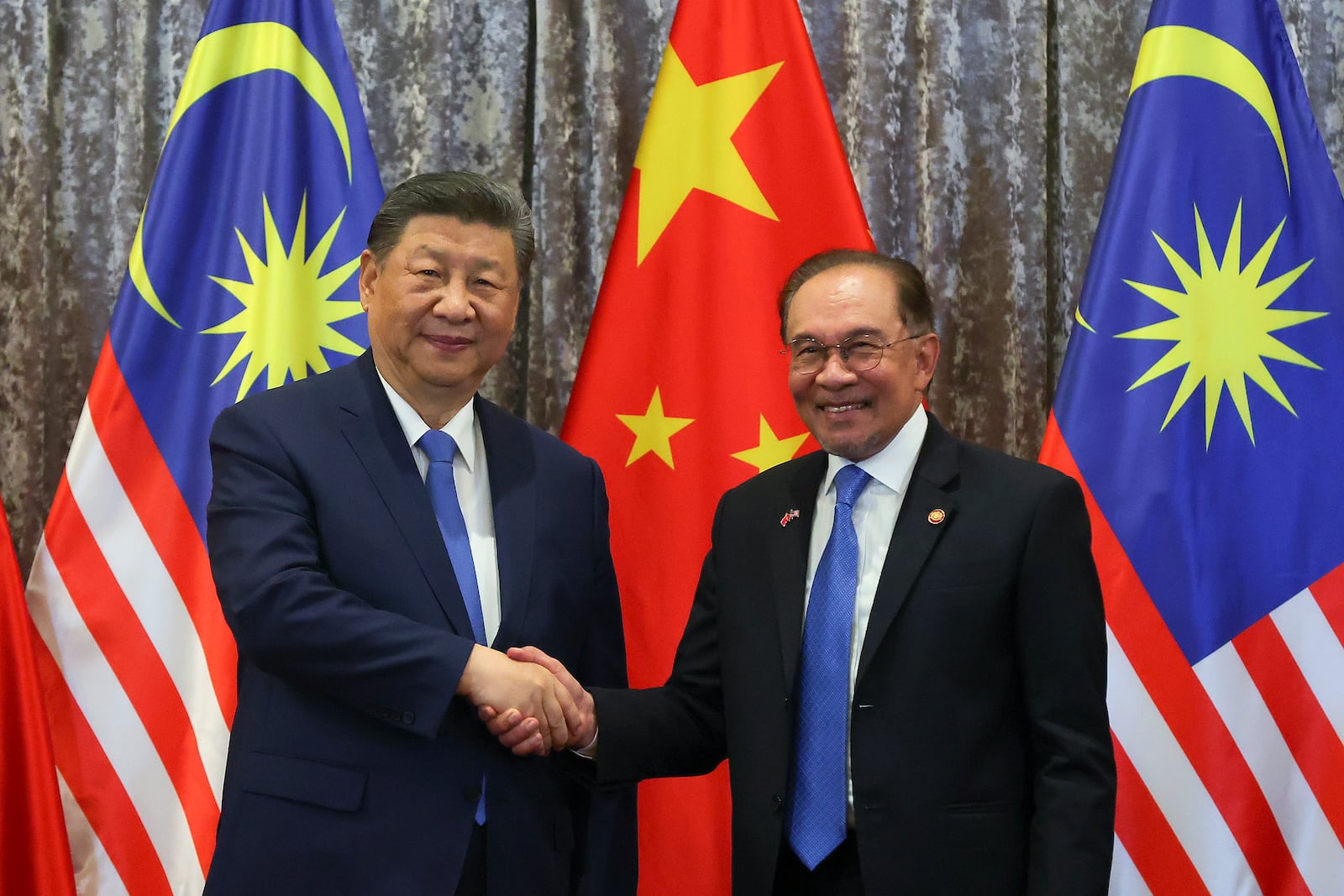 Chinese President Xi Jinping, left, and Malaysian Prime Minister Anwar Ibrahim shake hand after witnessing Exchange of Agreement session between the two countries at the official residence of the prime minister in Putrajaya, outside Kuala Lumpur, Malaysia, Wednesday April 16, 2025. (Fazry Ismail/Pool Photo via AP)