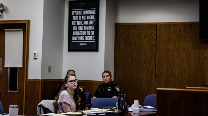Addy Michaels, center, waits for her attorneys during a sidebar at the opening of her trail at Montgomery County Common Pleas Court on Monday morning, June 5, 2023. JIM NOELKER/STAFF