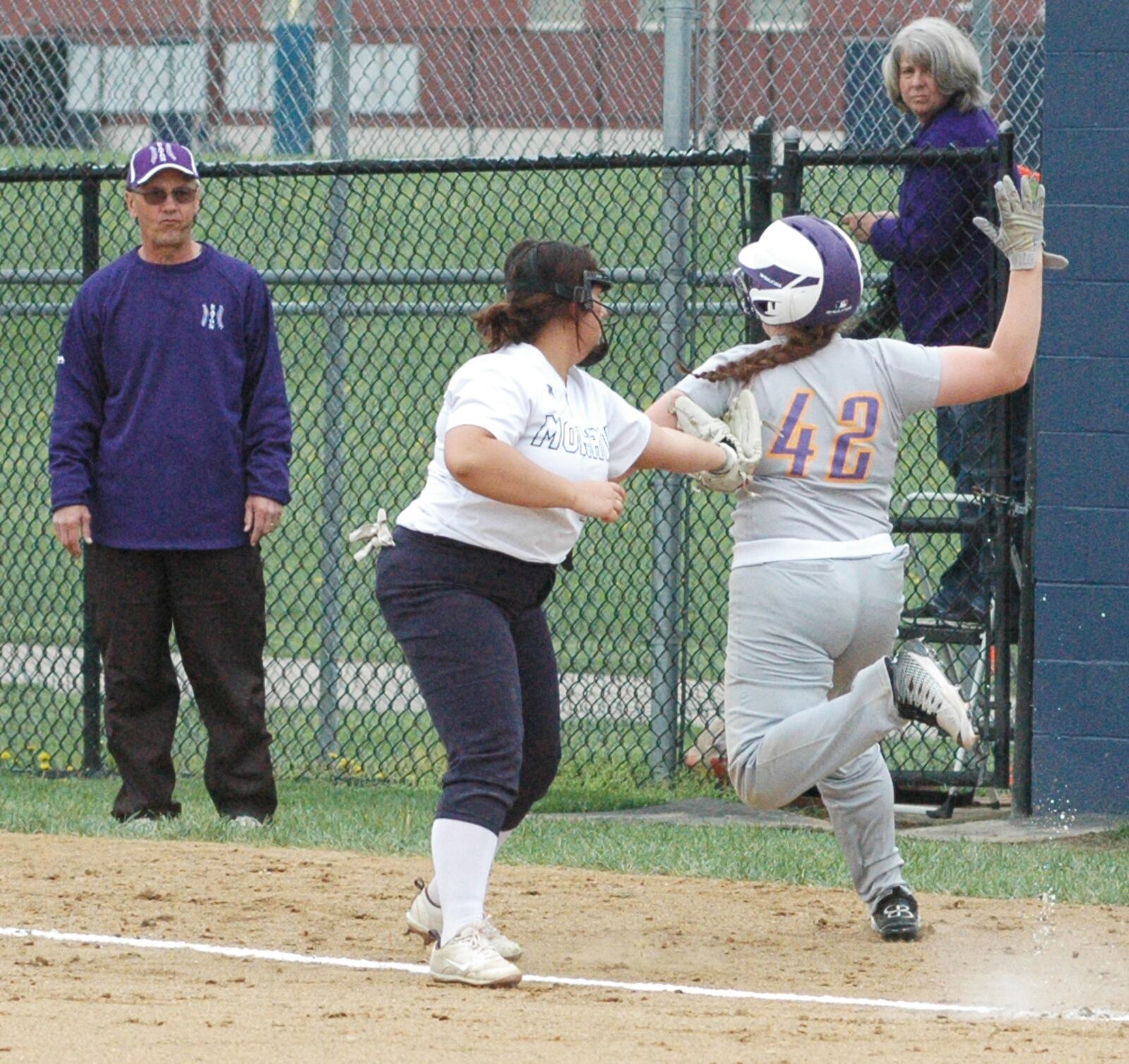 Monroe first baseman Makenzi Moore puts a tag on Eaton’s Rilee Worley (42) on Wednesday during a Southwestern Buckeye League Southwestern Division softball game at Monroe. Eaton won 5-1. RICK CASSANO/STAFF