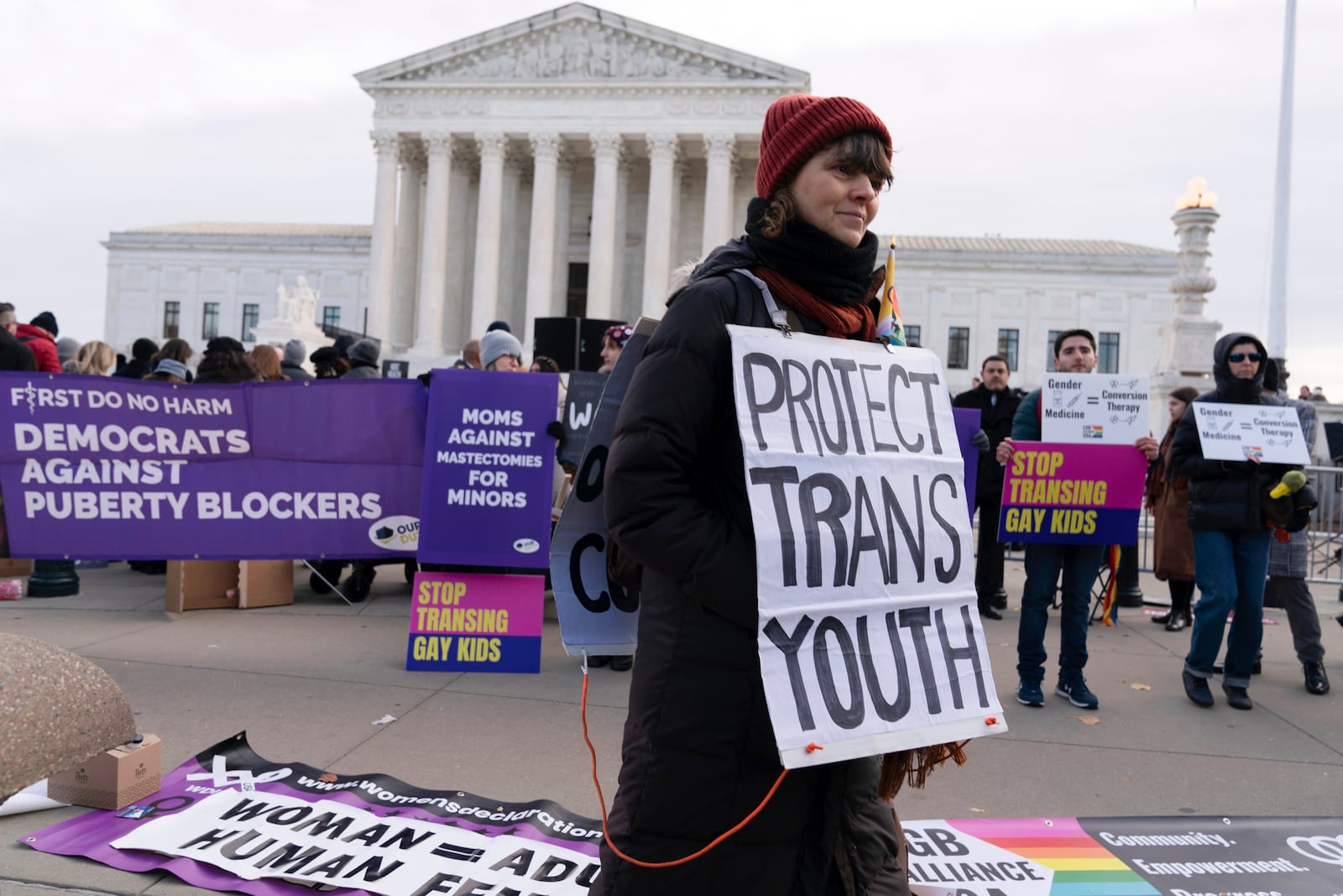 FILE - Protesters for and against gender-affirming care for transgender minors demonstrate outside the Supreme Court on Dec. 4, 2024, in Washington. (AP Photo/Jose Luis Magana, File)