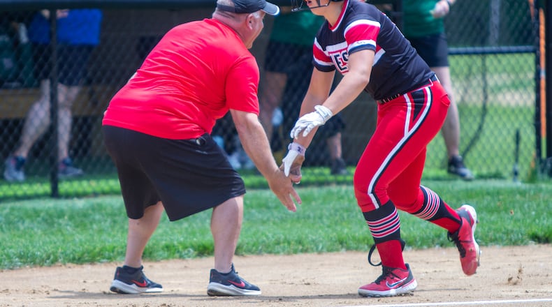 Lakota West's KK Mathis celebrates her first-inning home run with Firebirds coach Keith Castner during Thursday's Division I regional semifinal vs. Mason at Centerville High School. Jeff Gilbert/CONTRIBUTED