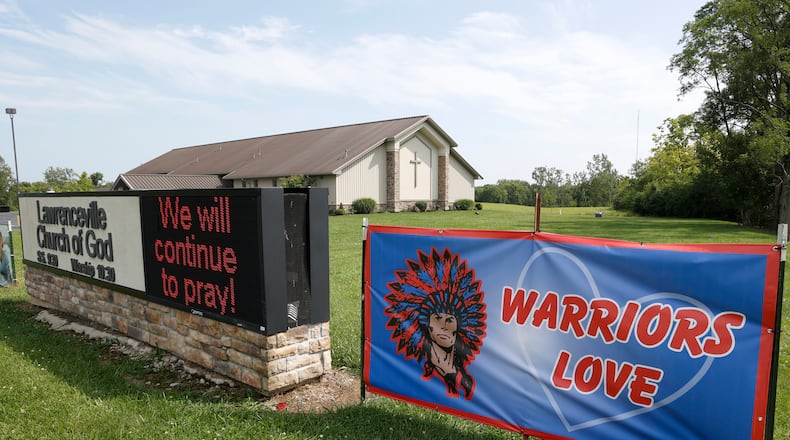 Signs in front of the Lawrenceville Church of God along Troy Road Thursday, August 24, 2024. BILL LACKEY/STAFF
