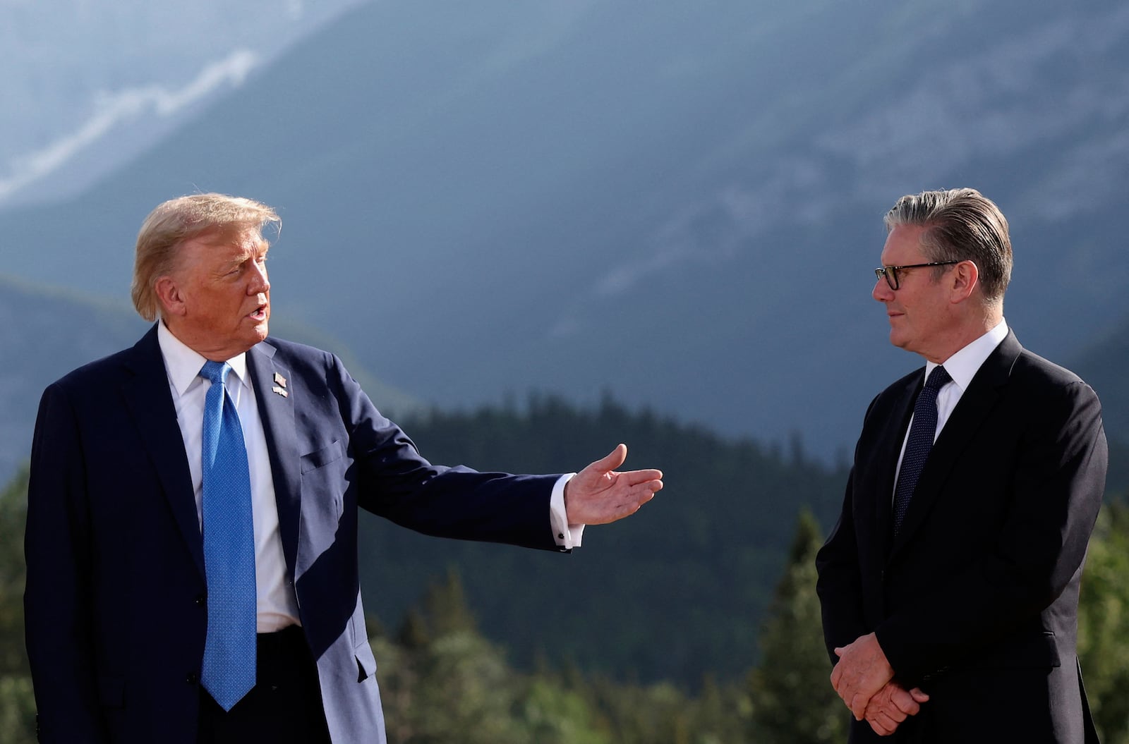 U.S. President Donald Trump, left, and Britain's Prime Minister Keir Starmer attend a family photo session during the G7 Summit, in Kananaskis, Alberta, Monday, June 16, 2025. (Suzanne Plunkett/Pool Photo via AP)
