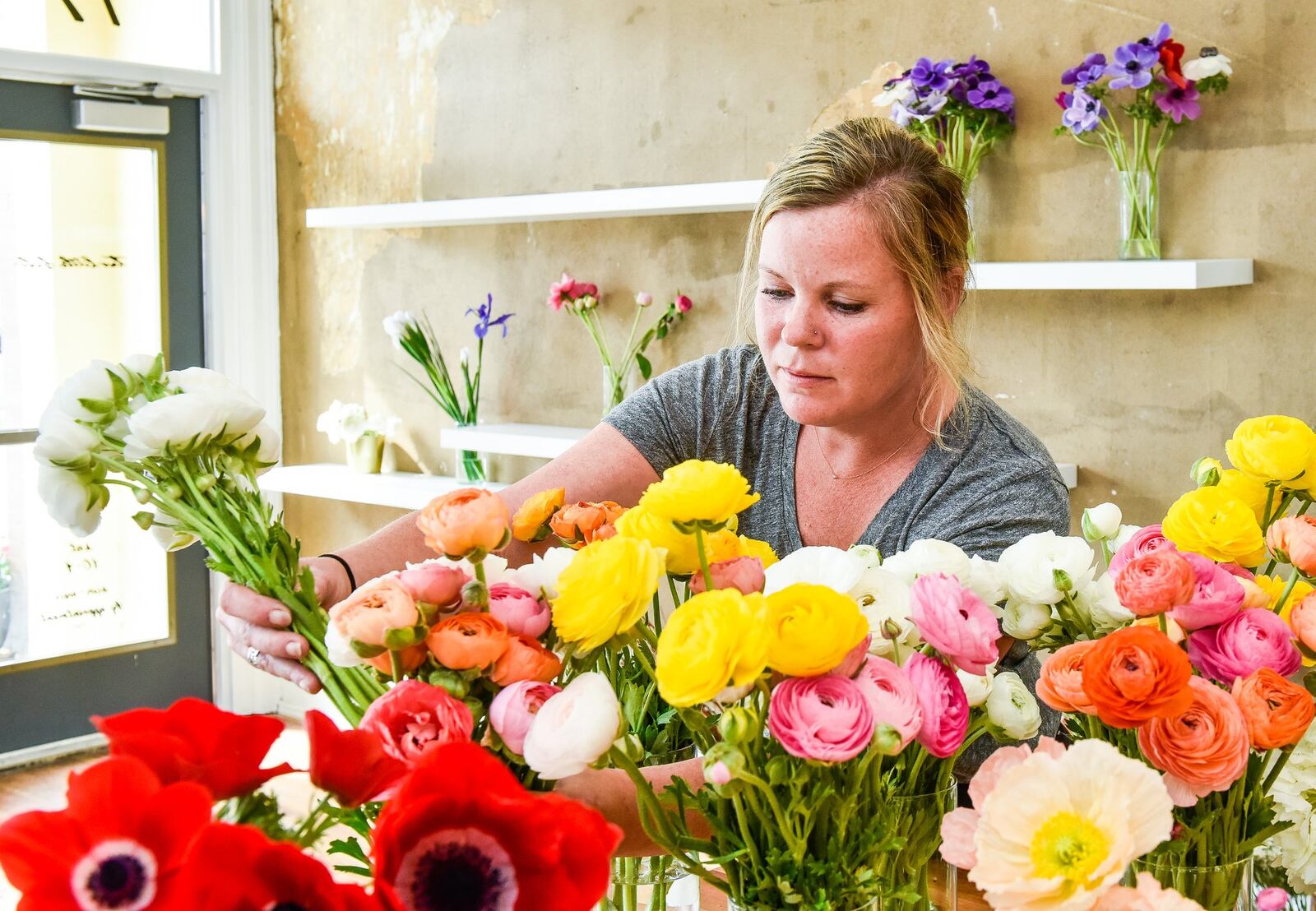 Mindy Staton prepares arrangements at Two Little Buds in Hamilton. The business recently moved from Bridgewater Falls to Hamilton and offers wedding and event arrangements. It specializes in locally grown flowers. 