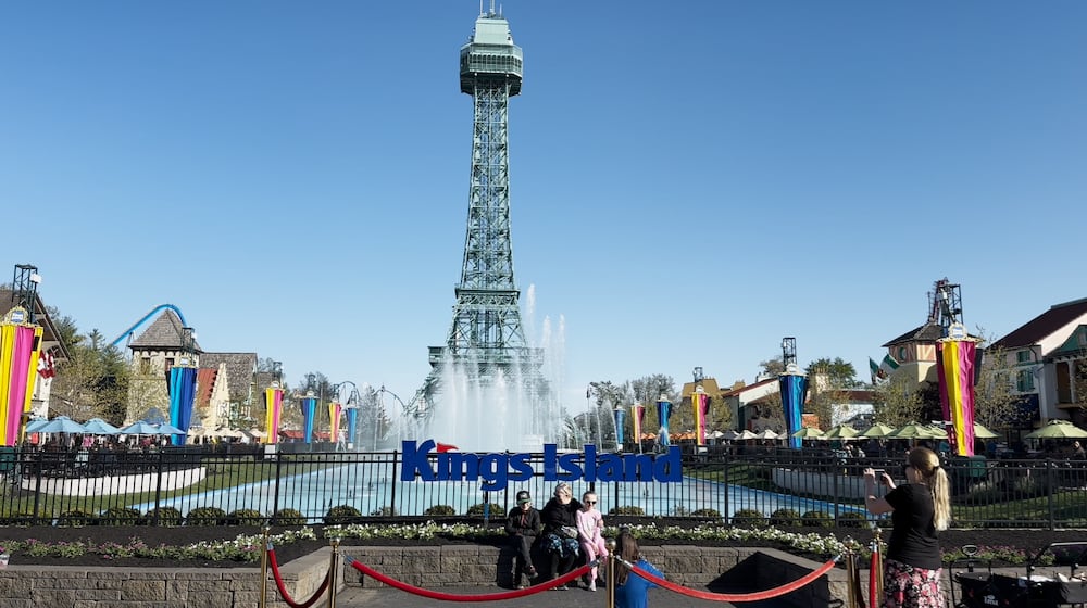 A family pauses for a photo in front of the Eiffel Tower at Kings Island on Saturday, April 20, 2024, which was the park's first open day for the 2024 season. CONTRIBUTED/KINGS ISLAND