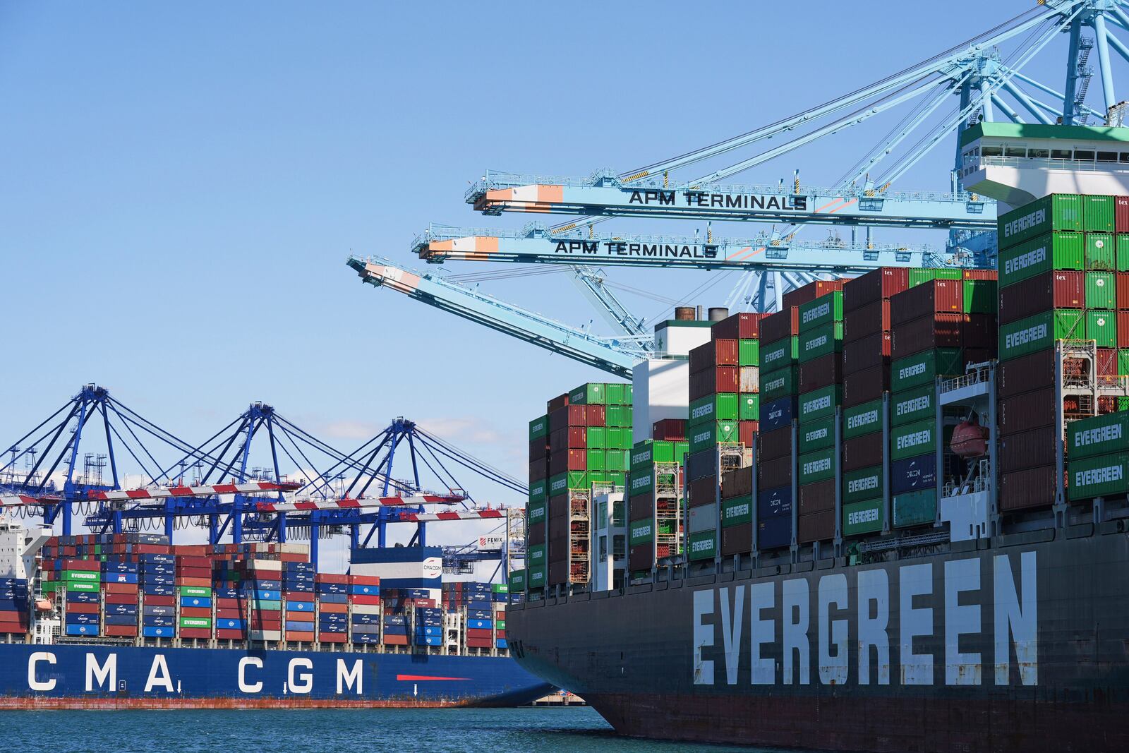 FILE - Ships are loaded with containers at the Port of Los Angeles, April 2, 2025, in Los Angeles. (AP Photo/Damian Dovarganes, File)