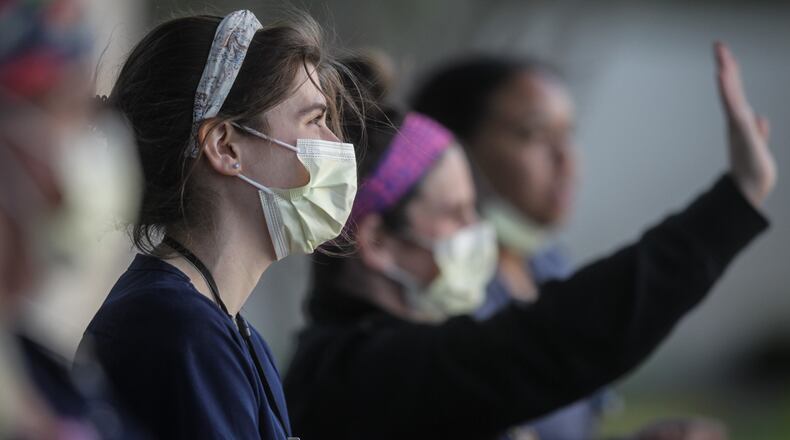 First responders from across the region honored health care workers Tuesday evening at multiple hospitals on the front lines of the coronavirus pandemic.At Miami Valley Hospital in Dayton, police and fire crews flashed lights and sounded sirens as hospital workers waved at the parade that circled the campus. PHOTO: Jim Noelker
