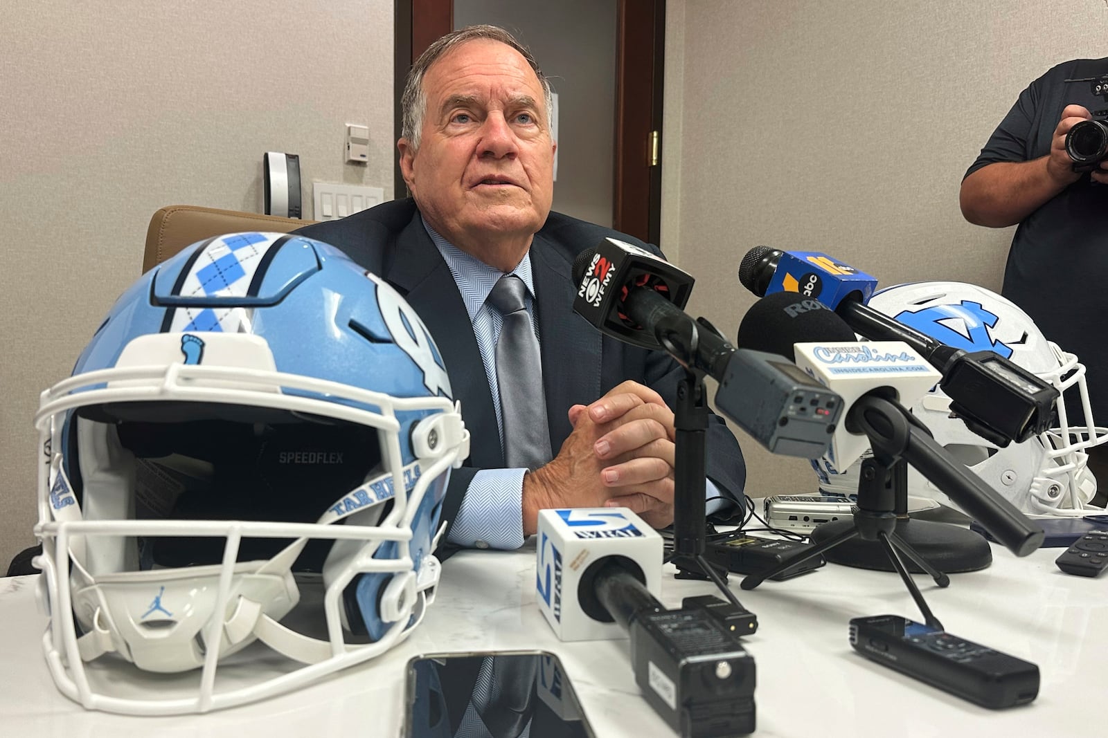 North Carolina coach Bill Belichick speaks with a group of reporters during the Atlantic Coast Conference's NCAA college football media days, Thursday, July 24, 2025, in Charlotte, N.C. (AP Photo/Aaron Beard)