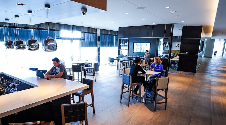Hotel patrons make use of the breakfast and bar area Friday, Dec. 30, 2016, at AC Hotel by Marriott at Liberty Center in Liberty Twp. The hotel industry is surging in Butler County suburbs of West Chester and Liberty townships. NICK GRAHAM/STAFF