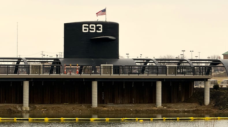 The $9.5 million USS Cincinnati nuclear submarine memorial is sailing through its construction schedule on time and now sports an American flag atop its conning tower after a recent ceremony. The regionally unique Cold War memorial, which will feature a full-size, walk-through replica along with original sections of the former USS Cincinnati attack submarine, saw organizers conduct a flag-raising ceremony for the coming historical site at West Chester Twp.’s Voice of America Metro Park. (Contributed)