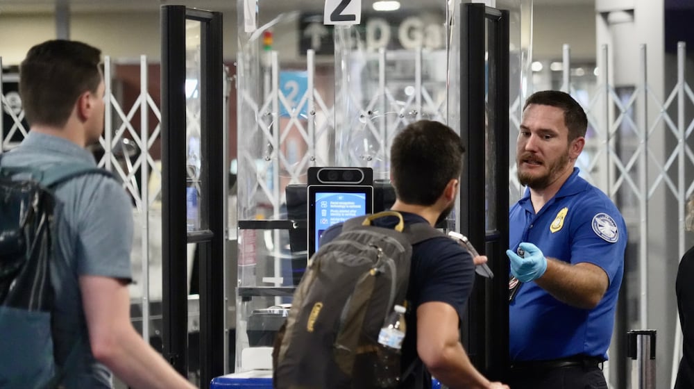 A TSA staff member at a check point at Harry Reid International Airport, Saturday, March 21, 2026, in Las Vegas. (AP Photo/Ty ONeil)