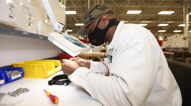 A Honda employee reviews his work assembling a Dynaflo compressor at the Technical Development Center in Marysville. Contributed