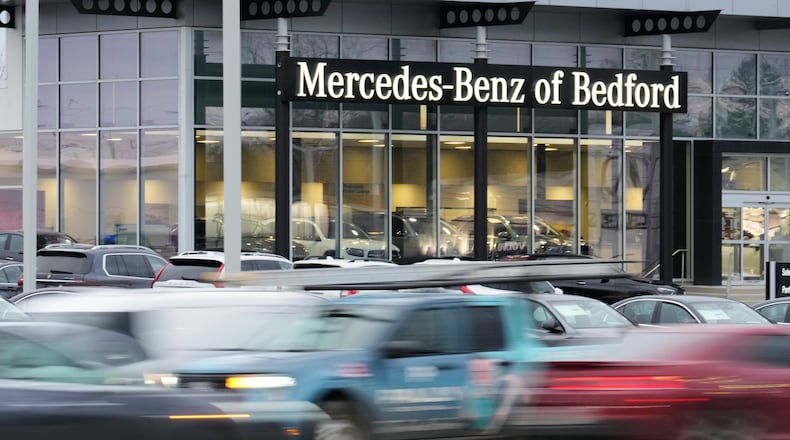 Cars drive by a Mercedes-Benz dealership on the Bedford Automile in Bedford, Ohio, Friday, Feb. 20, 2026. (AP Photo/Sue Ogrocki)