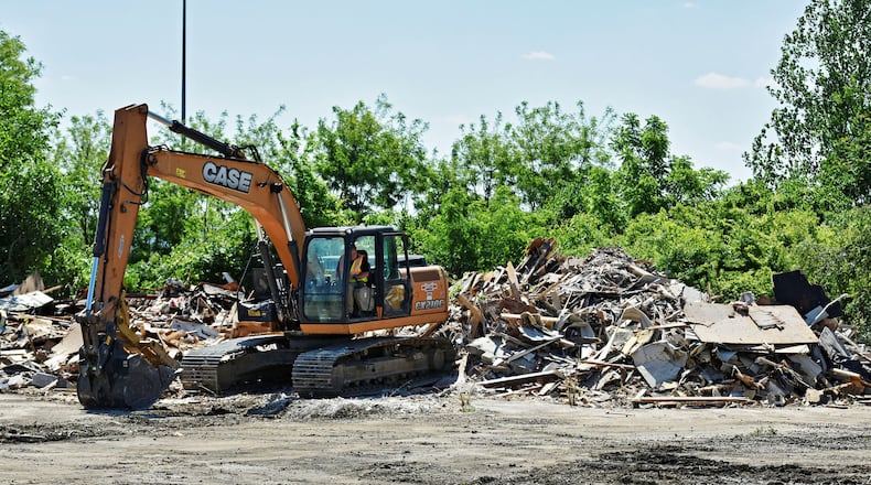Crews demolish the former Bristol’s Show Club, an adult entertainment club, on Thursday, May 24, in Monroe. NICK GRAHAM/STAFF