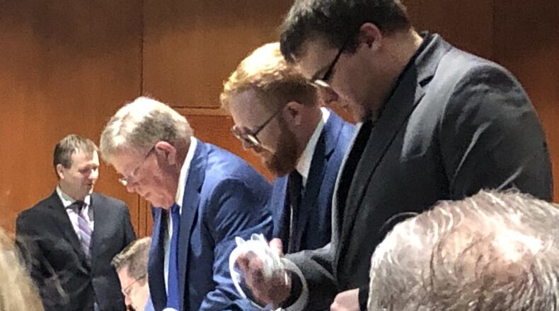 John Hopkins and the Chicarelli defense team prepare for trial Thursday. Warren County Prosecutor David Fornshell is in the background. STAFF/LAWRENCE BUDD