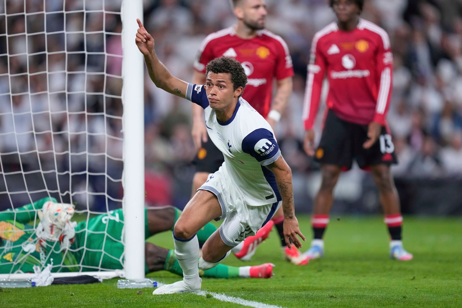 Tottenham's Brennan Johnson celebrates after scoring his side's opening goal during the Europa League final soccer match between Tottenham Hotspur and Manchester United at the San Mames Stadium in Bilbao, Spain, Wednesday, May 21, 2025. (AP Photo/Jose Breton)