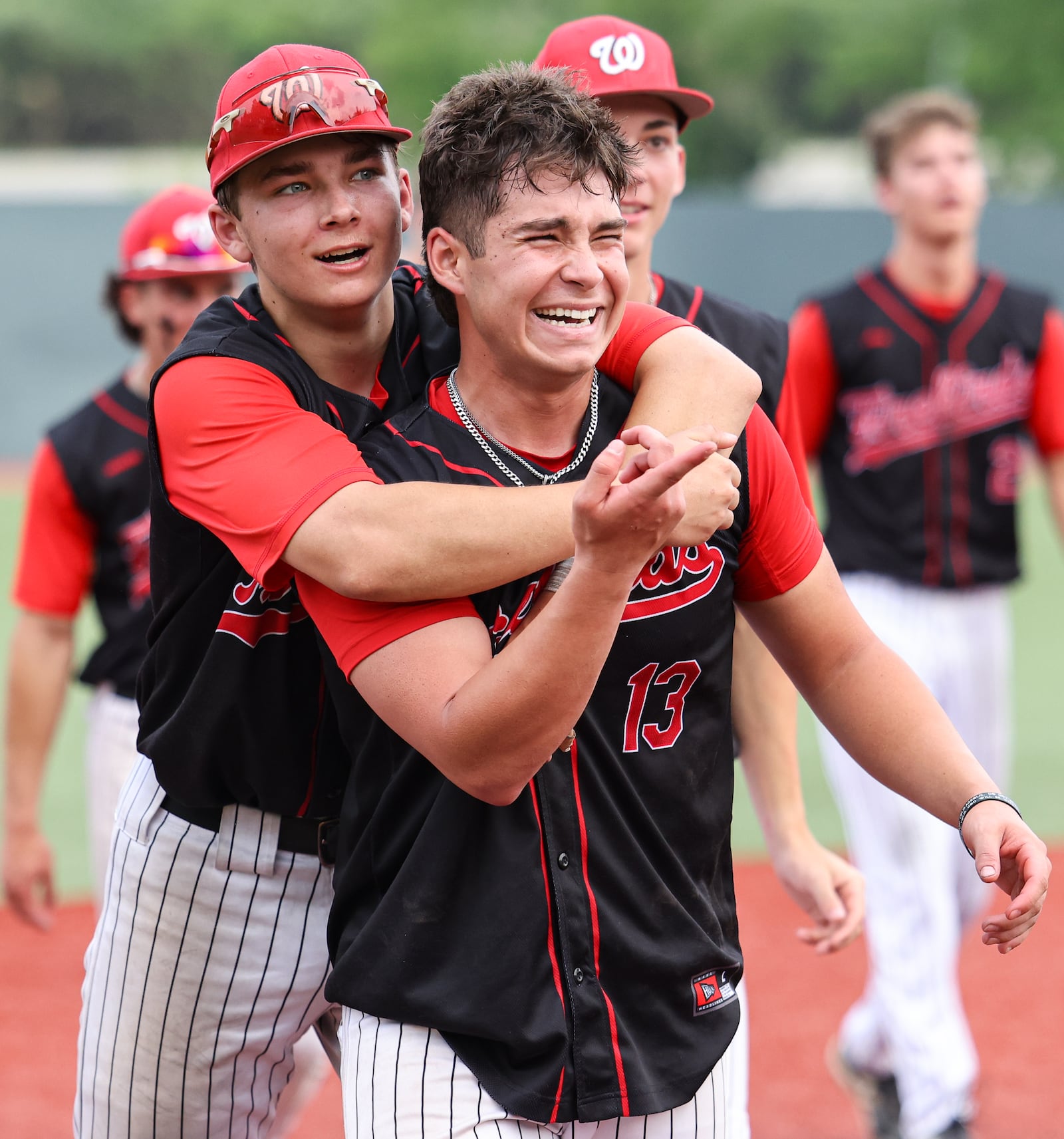 Lakota West junior Kameron Gaalaas celebrates with senior pitcher Adrian Smith after a 3-2 win over Cincinnati Moeller in a Division I regional final on Wednesday at Wright State University's Nischwitz Stadium. BRYANT BILLING / STAFF