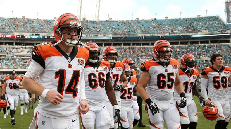 JACKSONVILLE, FL - NOVEMBER 05: Andy Dalton #14 of the Cincinnati Bengals leaves the field with his teammates at halftime of their game against the Jacksonville Jaguars at EverBank Field on November 5, 2017 in Jacksonville, Florida. (Photo by Logan Bowles/Getty Images)