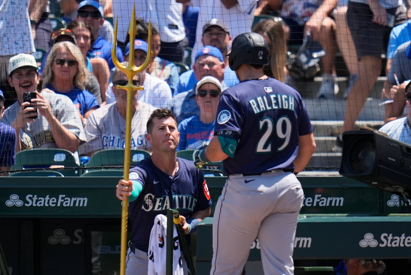 Seattle Mariners' Cal Raleigh (29), right, receives the home run trident from Dylan Moore (25) after hitting a home run during the first inning of a baseball game against the Chicago Cubs, Friday, June 20, 2025, in Chicago. (AP Photo/Erin Hooley)
