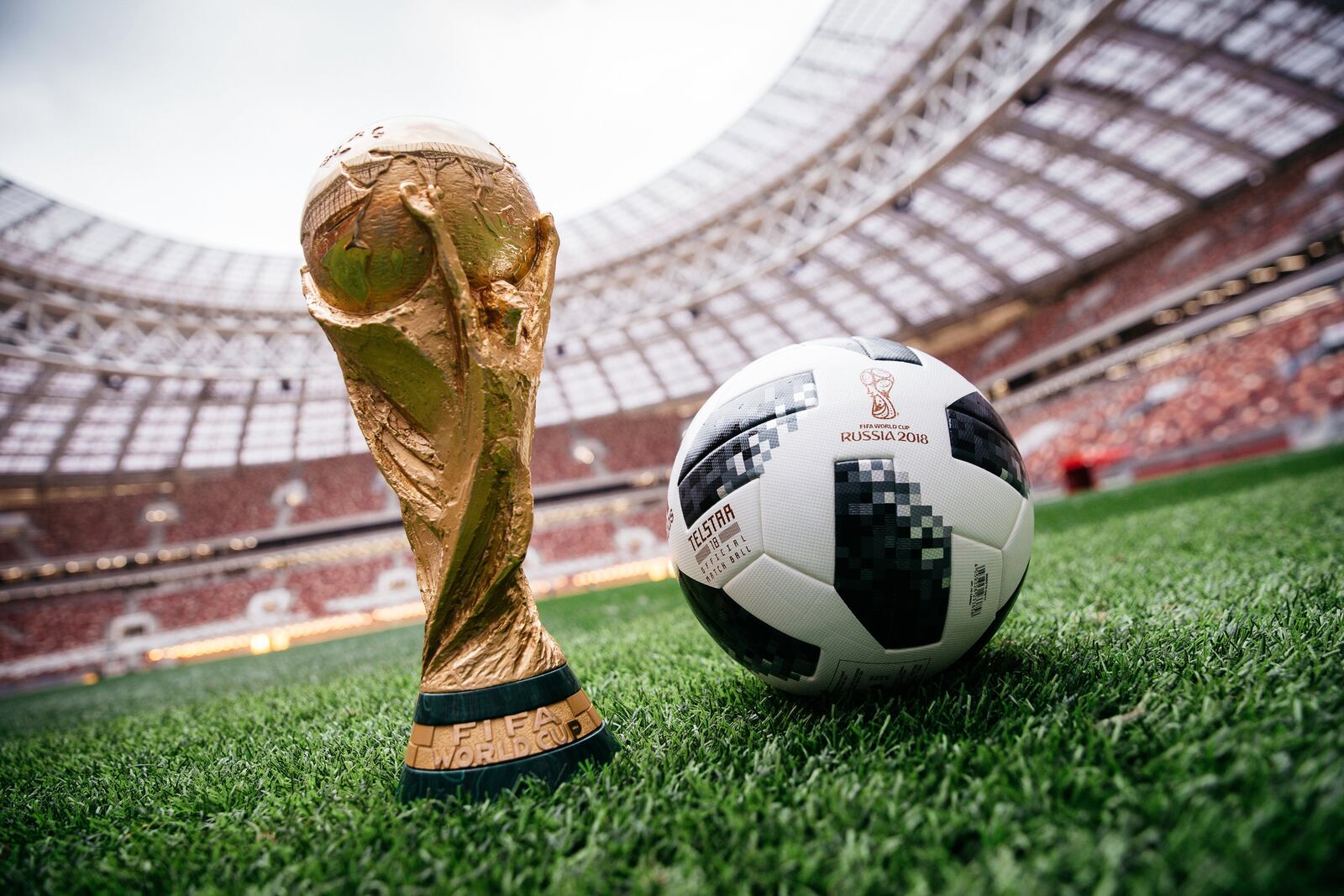 An adidas official match ball, named Telstar 18, sits next to the FIFA World Cup trophy in Luzhniki Stadium in Moscow.