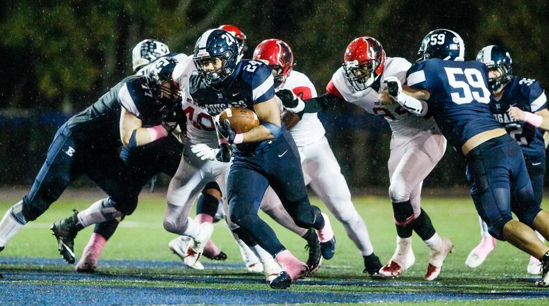 Edgewood’s Elijah Williams breaks through the Mount Healthy defense for a touchdown during Friday night’s game at Kumler Field in St. Clair Township. NICK GRAHAM/STAFF