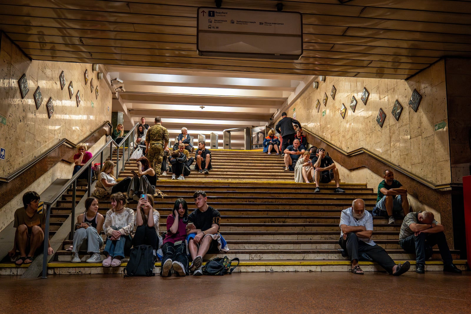 People rest in a metro station, being used as a bomb shelter, during a Russian drones attack in Kyiv, Ukraine, early Friday, June 6, 2025. (AP Photo/Dan Bashakov)