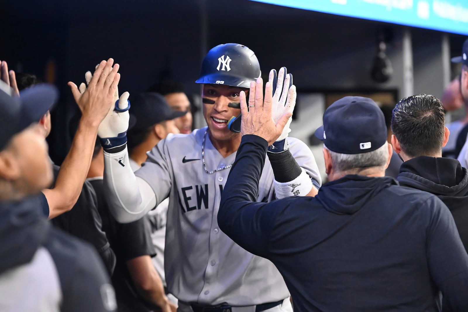New York Yankees' Aaron Judge (99) celebrates in the dugout after hitting a two-run home run against the Toronto Blue Jays in the sixth inning of a baseball game in Toronto on Wednesday, July 23, 2025. (Jon Blacker/The Canadian Press via AP)