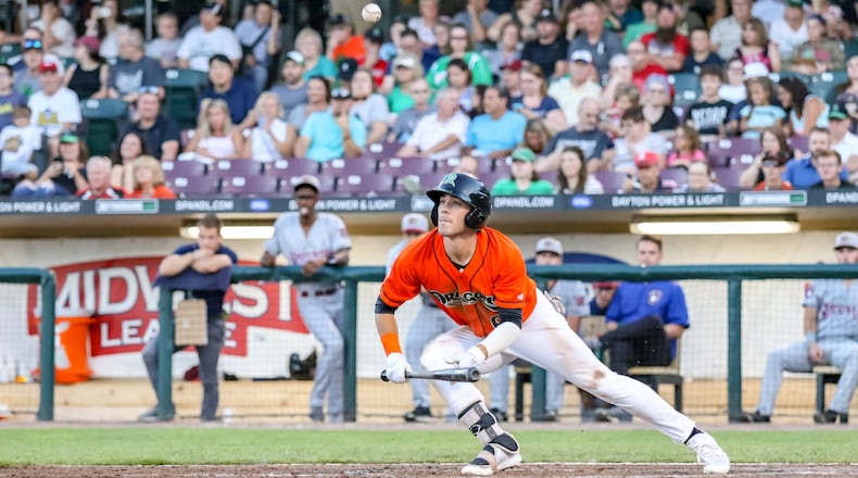 Dayton Dragons centerfielder Michael Siani watches his bunt attempt fly into the air during their game against the Wisconsin Timber Rattlers on Friday night at Fifth Third Field. The Timber Rattlers won 4-2. CONTRIBUTED PHOTO BY MICHAEL COOPER