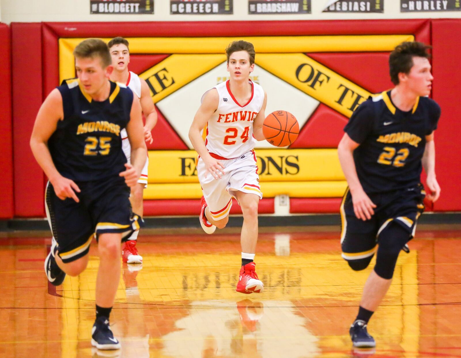 Fenwick guard David Luers (24) brings the ball upcourt behind Monroe’s Matt DeHart (25) and Tucker Triplett (22) on Tuesday night at Fenwick. GREG LYNCH/STAFF