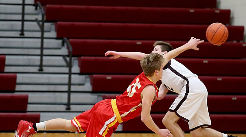 Fenwick forward Luke Bradshaw gets off a pass as Lebanon guard Sammy Stotts pressures during their game at Lebanon on Dec. 17, 2016. COX MEDIA FILE PHOTO