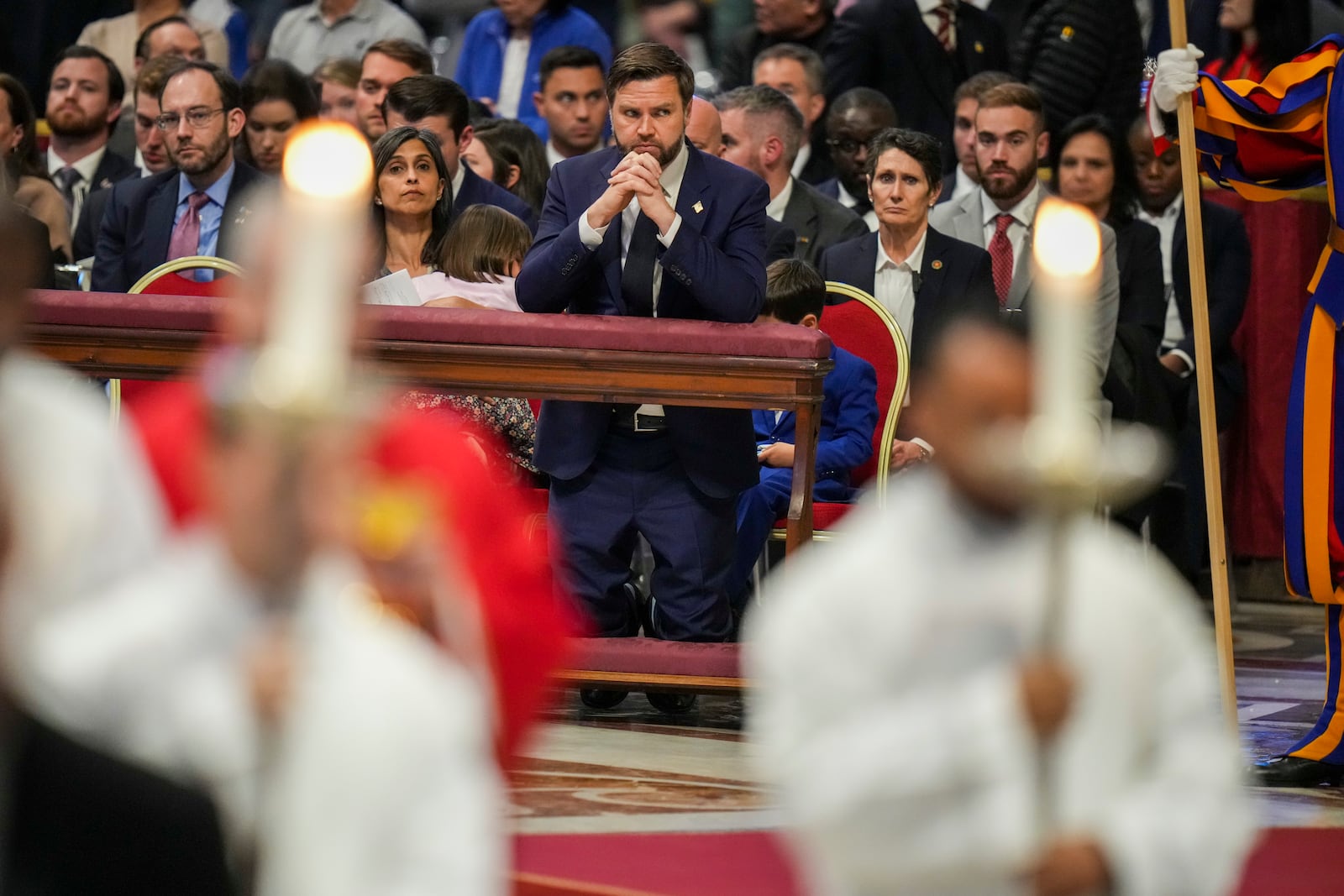 U.S. Vice President JD Vance attends with his wife Usha, left, a Good Friday service inside St. Peter's Basilica at the Vatican, Friday, April 18, 2025. (AP Photo/Alessandra Tarantino)