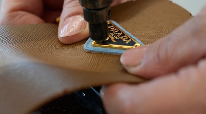 A leather good operator works at the Prada factory in Scandicci, Italy, Friday, Nov. 28, 2025. (AP Photo/Gregorio Borgia, File)