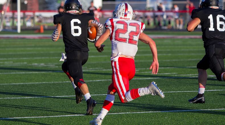 Franklin's Reagen Brown outruns Carlisle's Talon Borders on a 70-yard interception return for a touchdown in the first quarter Friday night at Franklin. The Wildcats won 7-0. Jeff Gilbert/CONTRIBUTED