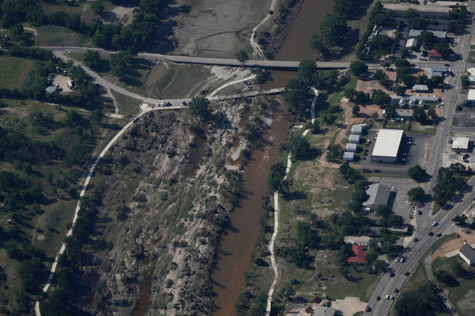 Water flows through the Guadalupe River on Tuesday, July 8, 2025, after a flash flood swept through the area in Kerrville, Texas. (AP Photo/Ashley Landis)